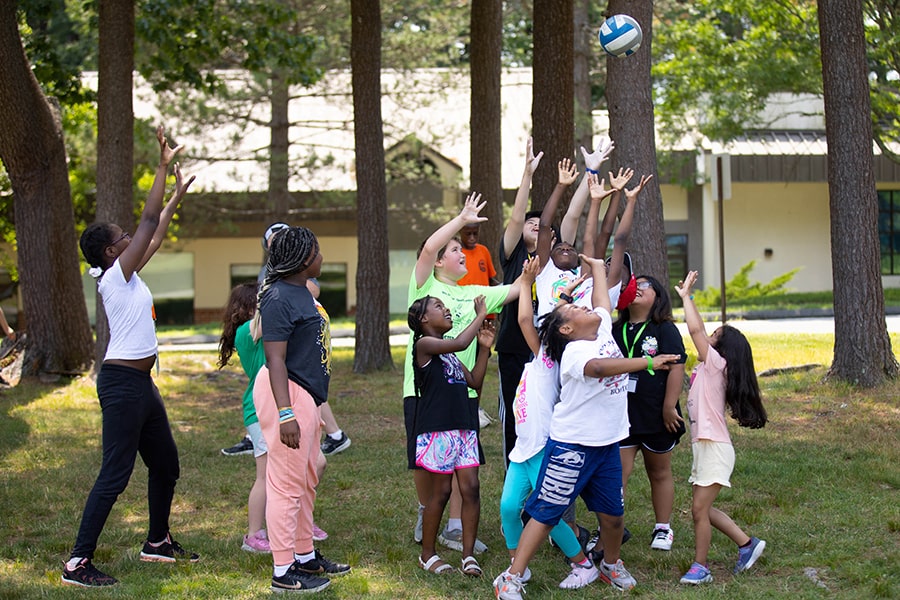 Camp Shriver kids reaching for ball in the air