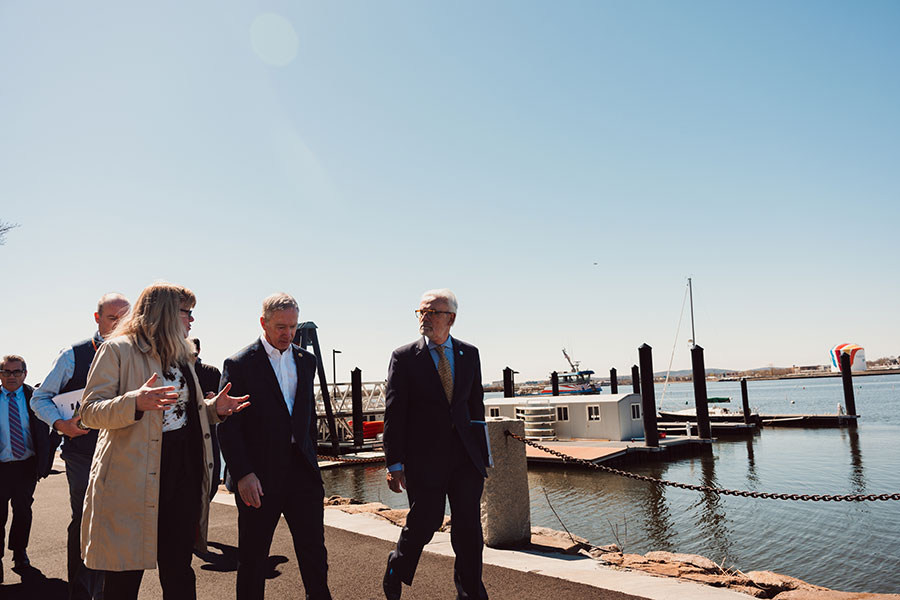 Chancellor and Rep. Lynch walk on campus by the harbor