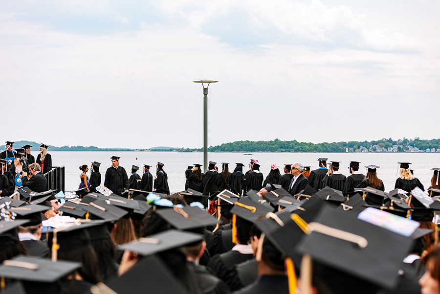 Graduates at 2024 commencement by the water