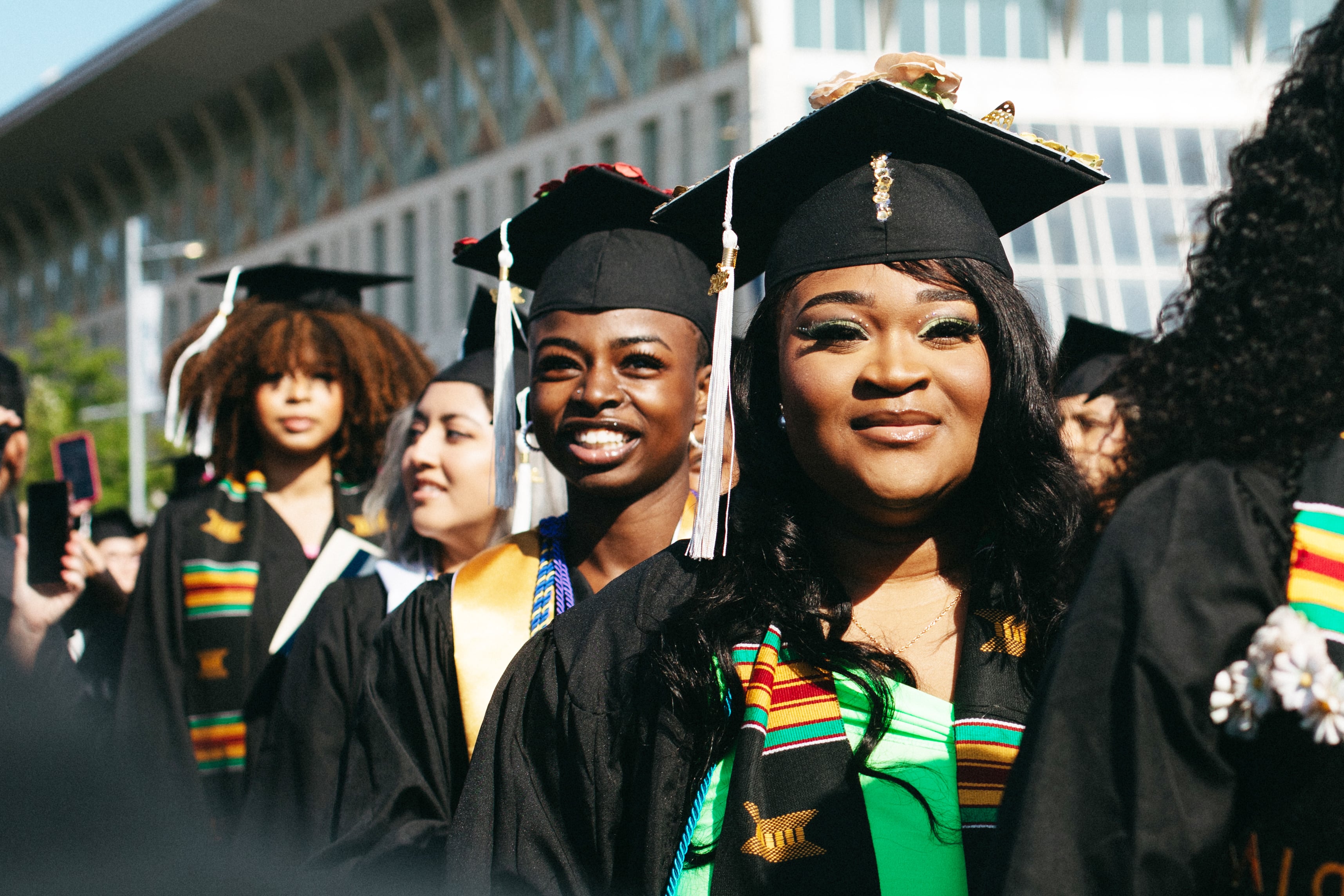 Four female students at UMass Boston's Commencement ceremony