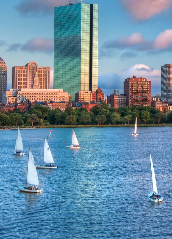 sailboats in front of Boston skyline