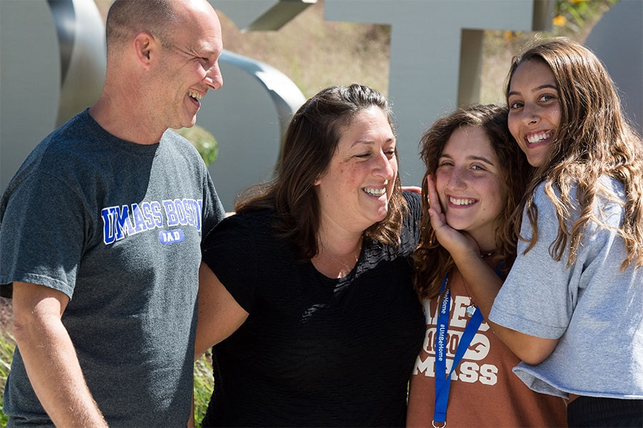 parents embrace enrolled UMass Boston Student on Move In Day